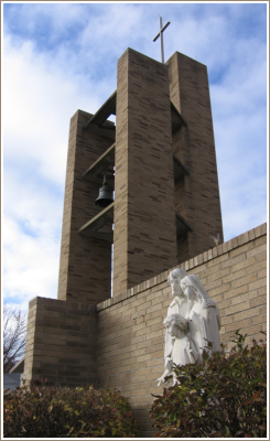 Holy Family statue in the prayer garden alongside our bell tower